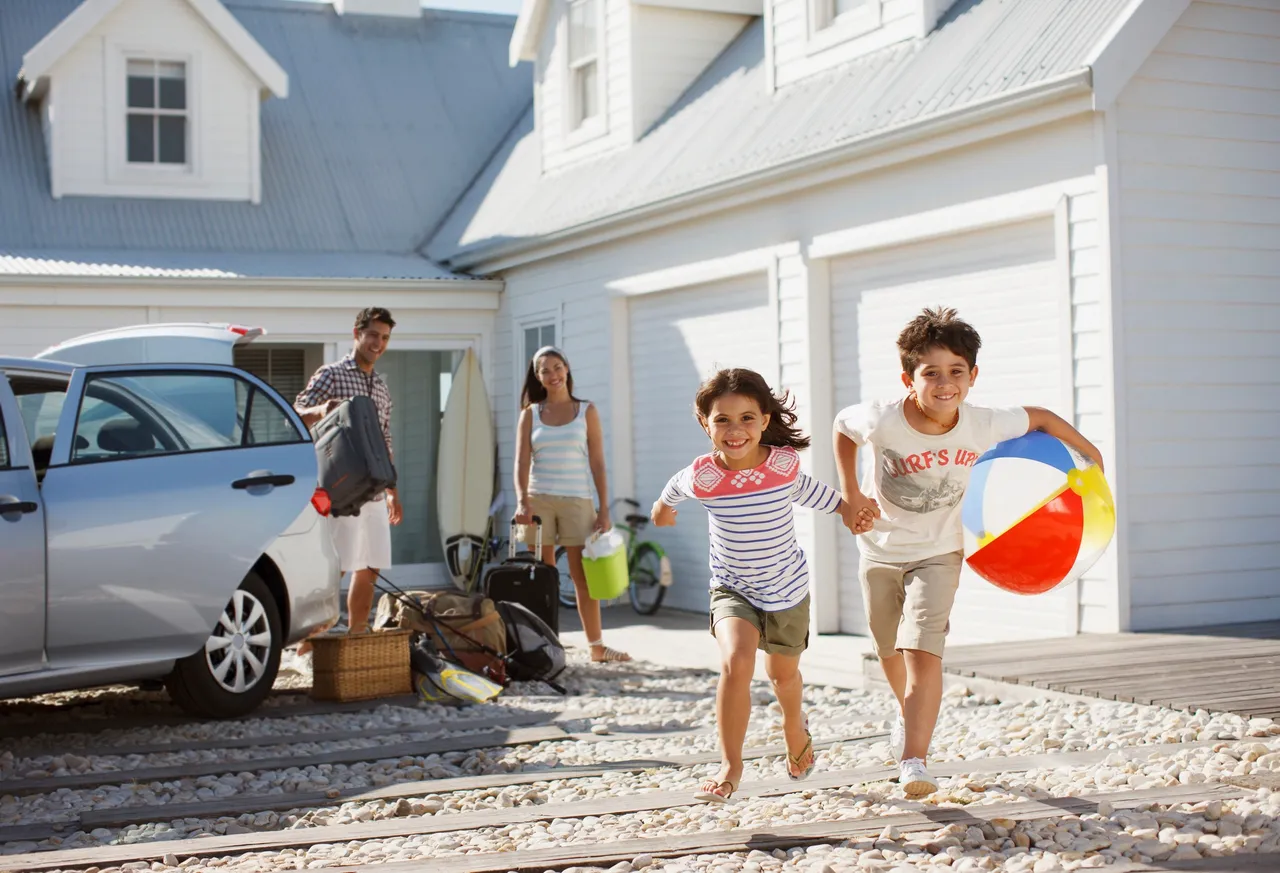 Family unpacking car for vacation